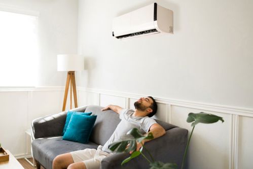 man under aircon unit