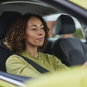 Woman Driving A Green Car