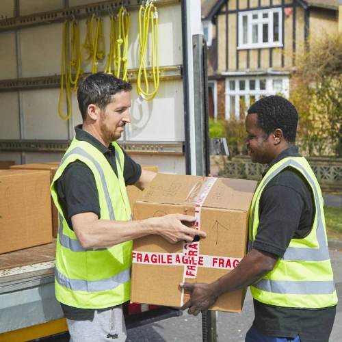 Couriers handing parcels to each other