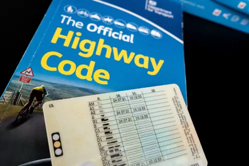 British Provisional Driving Licence on top of The Official Highway Code.