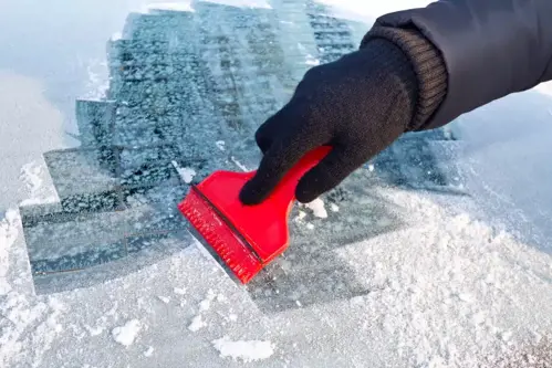 scraping ice off windscreen