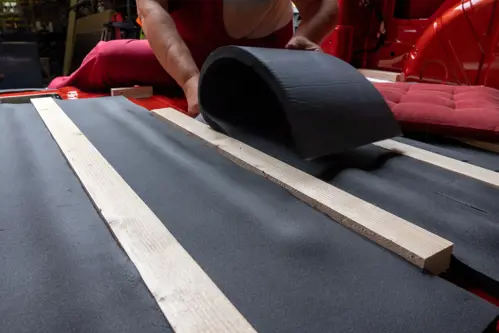 man insulating the floor of his van
