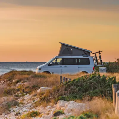 Campervan Next To Coastal Sunset