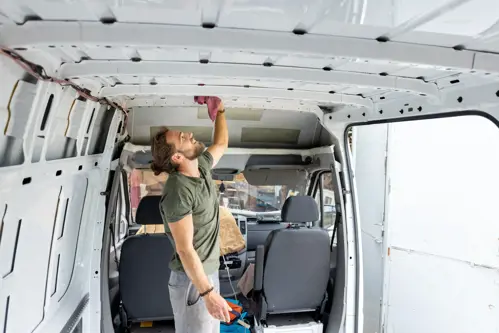 man cleaning his van interior