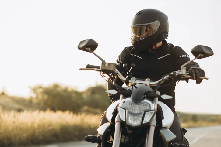 Man biker riding his motorbike on highway